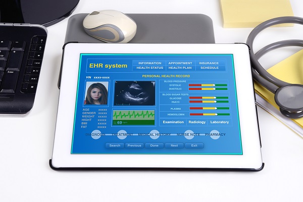 Electronic health record showing on a tablet sitting on a desk.